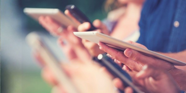 People using mobile devices in public places