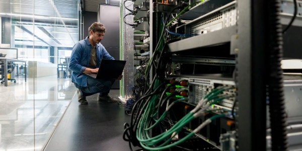 Technician maintaining low latency interconnections